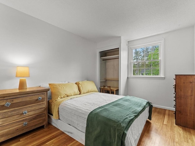 bedroom with wood finished floors and baseboards