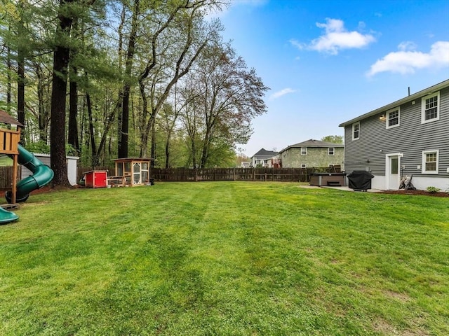 view of yard featuring a jacuzzi and a playground