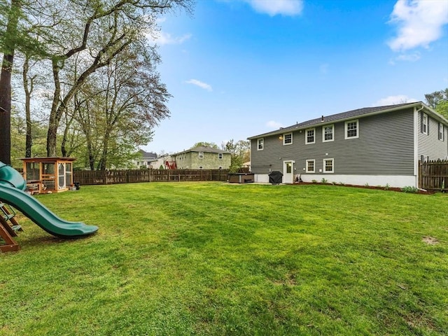 back of house with a playground