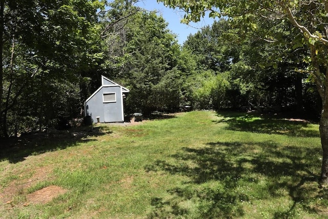 40 Revere St, Gloucester, MA 01930 - view of grassy yard with a shed and a forest view
