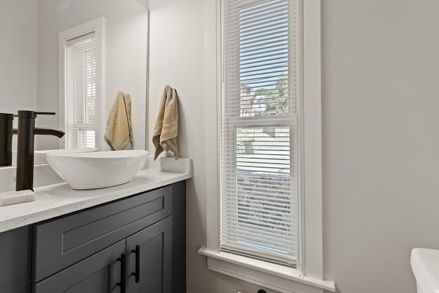 bathroom featuring vanity and toilet