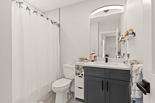 bathroom featuring tile patterned floors, a shower with curtain, vanity, and toilet