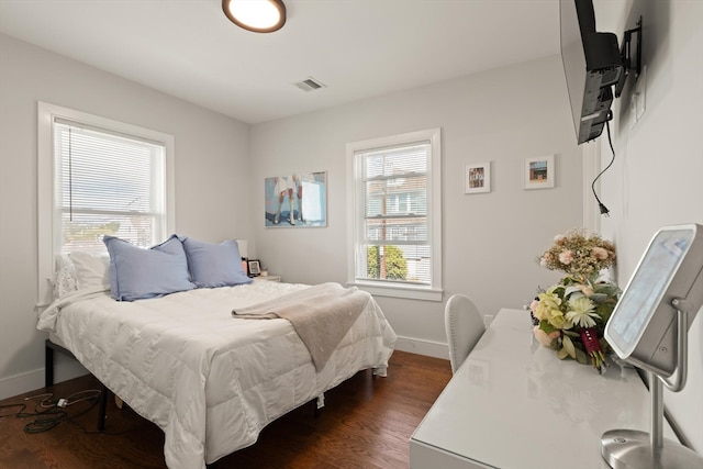 bedroom with dark wood-type flooring