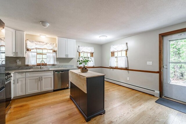 53 Greenleaf Dr, Hampden, MA 01036 - kitchen with stainless steel dishwasher, baseboard heating, light wood-type flooring, a sink, and a textured ceiling