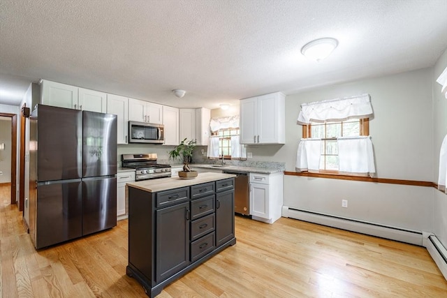 53 Greenleaf Dr, Hampden, MA 01036 - kitchen with stainless steel appliances, white cabinetry, light wood-type flooring, light countertops, and a textured ceiling
