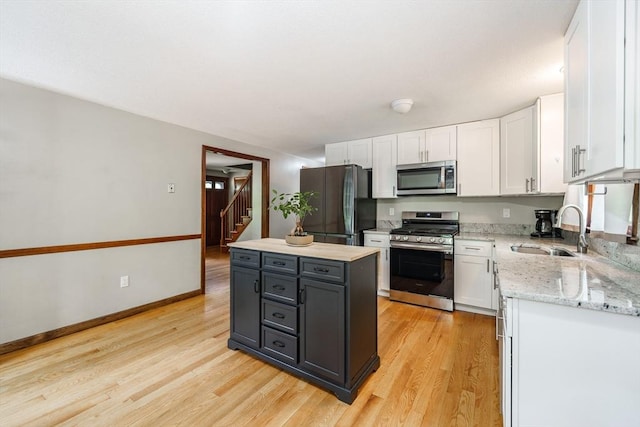 53 Greenleaf Dr, Hampden, MA 01036 - kitchen featuring stainless steel appliances, a sink, white cabinets, and light wood-style flooring