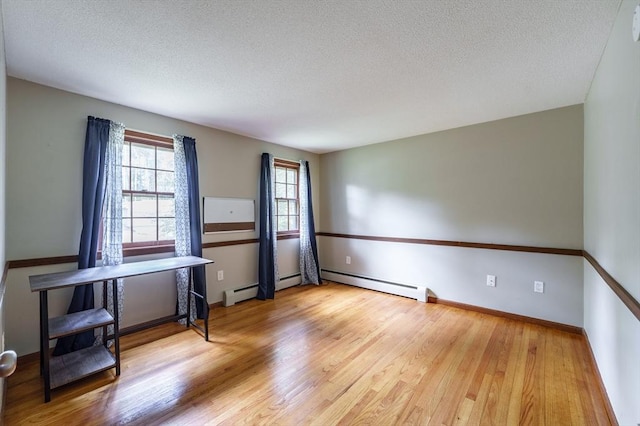 53 Greenleaf Dr, Hampden, MA 01036 - unfurnished room with baseboard heating, a textured ceiling, wood finished floors, and baseboards