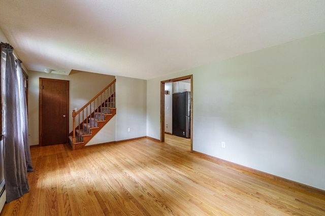 53 Greenleaf Dr, Hampden, MA 01036 - unfurnished living room featuring light wood-style flooring, stairs, baseboards, and a baseboard heating unit