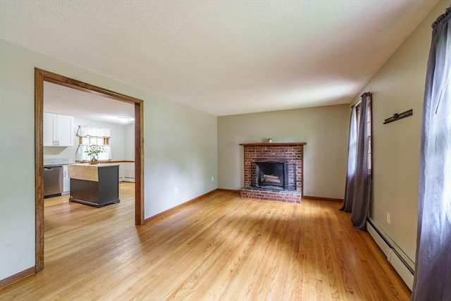 53 Greenleaf Dr, Hampden, MA 01036 - unfurnished living room with a baseboard heating unit, light wood-style floors, and a fireplace
