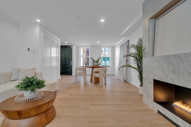 interior space with ornamental molding and light hardwood / wood-style flooring