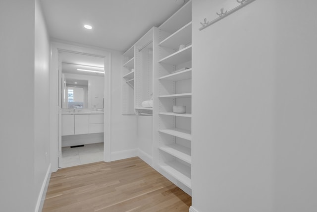 spacious closet featuring light tile floors