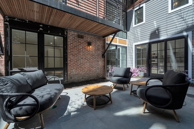 view of patio featuring outdoor lounge area and a balcony