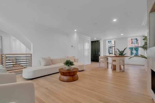 living room featuring light hardwood / wood-style flooring and ornamental molding