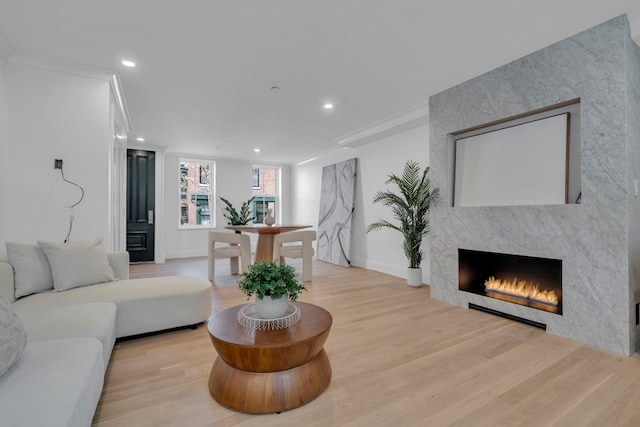 living room featuring light hardwood / wood-style flooring and ornamental molding