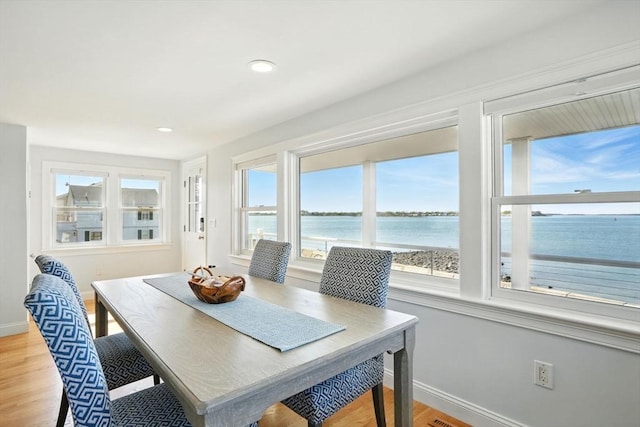 119 Fort Point Rd, Weymouth, MA 02191 - dining area with baseboards, a water view, light wood-style flooring, and recessed lighting