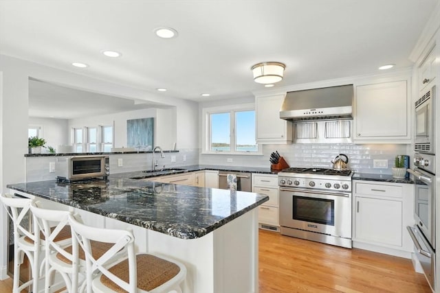 119 Fort Point Rd, Weymouth, MA 02191 - kitchen with stainless steel appliances, wall chimney exhaust hood, a sink, a warming drawer, and healthy amount of natural light