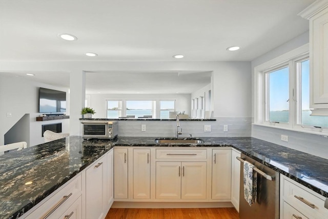 119 Fort Point Rd, Weymouth, MA 02191 - kitchen featuring a sink, dishwasher, decorative backsplash, light wood-style floors, and recessed lighting