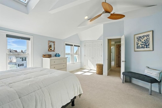 119 Fort Point Rd, Weymouth, MA 02191 - bedroom featuring light carpet, lofted ceiling, a skylight, ceiling fan, and a closet