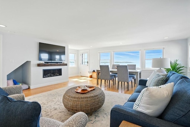 119 Fort Point Rd, Weymouth, MA 02191 - living area with wood finished floors, a glass covered fireplace, recessed lighting, and baseboards