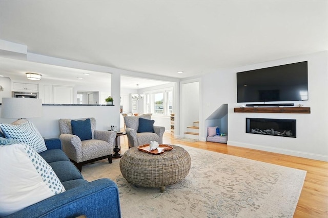 119 Fort Point Rd, Weymouth, MA 02191 - living room featuring light wood-type flooring, a fireplace, stairway, recessed lighting, and a chandelier