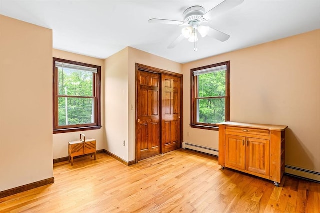 906 Clark St, Gardner, MA 01440 - bedroom featuring a baseboard heating unit, multiple windows, light wood finished floors, and baseboards