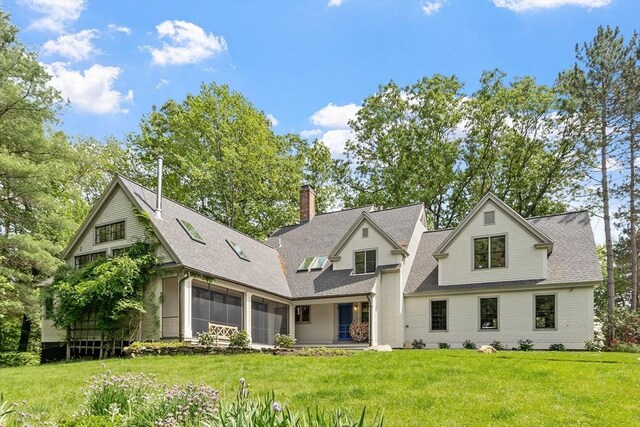 429 School St, Carlisle, MA 01741 - view of front of property with a shingled roof, a chimney, a front yard, a sunroom, and an attached garage