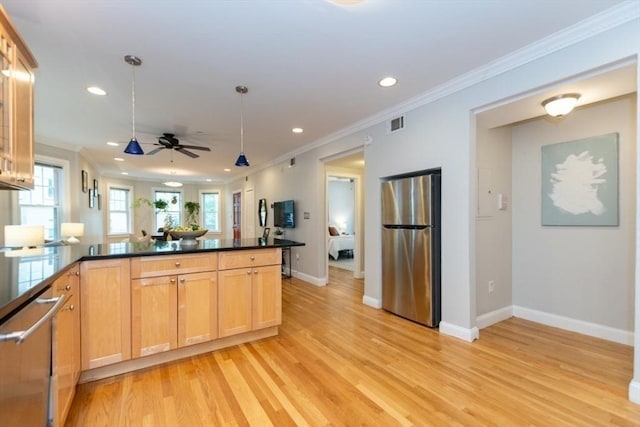 68 Line St Unit 2, Somerville, MA 02143 - kitchen with appliances with stainless steel finishes, ornamental molding, dark countertops, light wood-style flooring, and recessed lighting