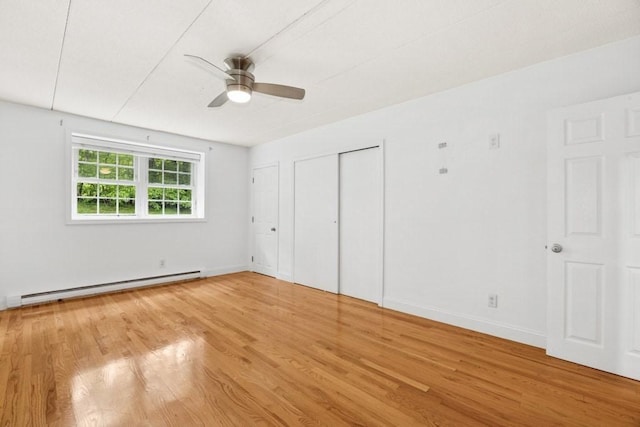 153 Milk St Unit 4, Westborough, MA 01581 - unfurnished bedroom featuring a baseboard heating unit, wood finished floors, baseboards, and ceiling fan