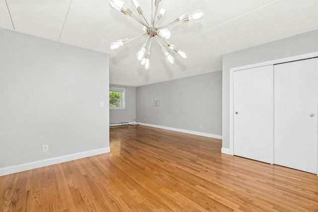 153 Milk St Unit 4, Westborough, MA 01581 - unfurnished bedroom with a chandelier, light wood-type flooring, baseboards, and a closet