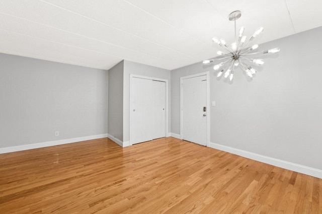 153 Milk St Unit 4, Westborough, MA 01581 - empty room featuring a chandelier, baseboards, and light wood-style flooring