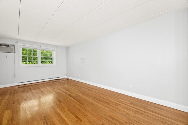 153 Milk St Unit 4, Westborough, MA 01581 - empty room with a baseboard radiator, wood finished floors, baseboards, and a wall mounted AC