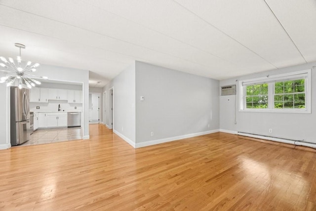 153 Milk St Unit 4, Westborough, MA 01581 - unfurnished living room with light wood finished floors, a chandelier, and baseboards