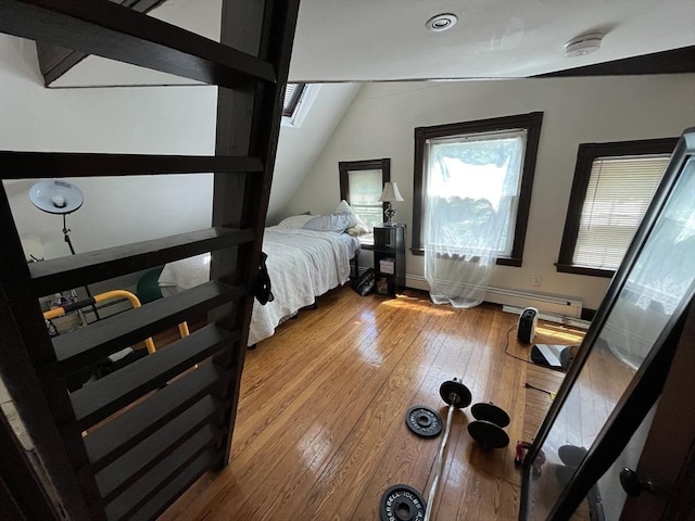 5-7 Prescott Pl, Boston, MA 02134 - bedroom with wood-type flooring, lofted ceiling, and a baseboard heating unit