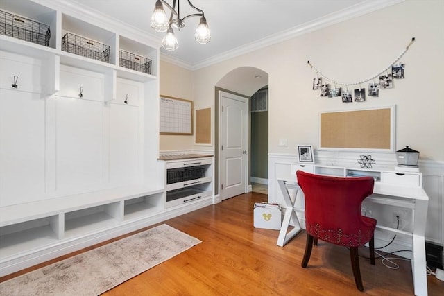 home office with hardwood / wood-style flooring, ornamental molding, and a notable chandelier