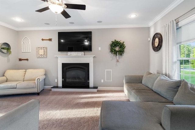 living room with ornamental molding, ceiling fan, and carpet flooring