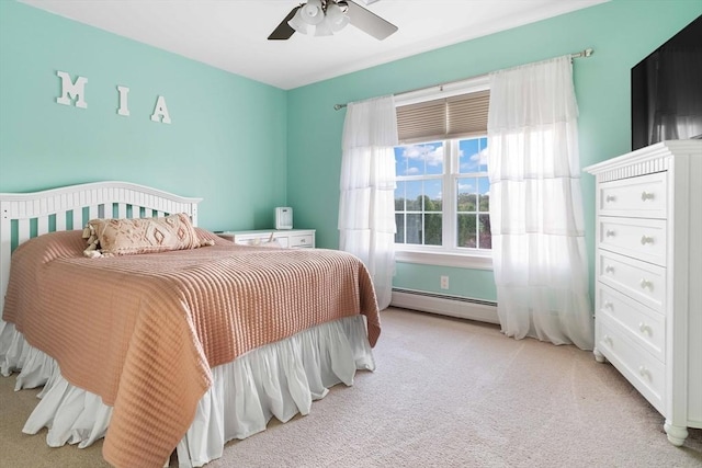 bedroom with ceiling fan, light colored carpet, and a baseboard radiator