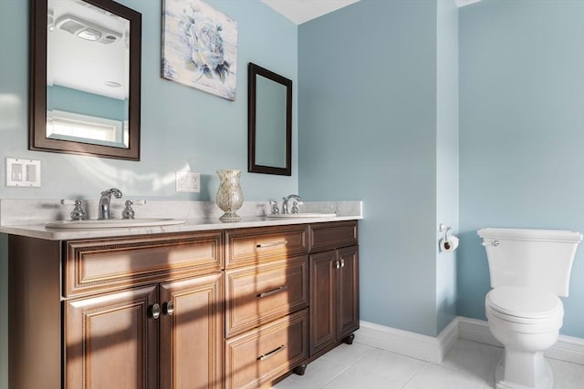 bathroom with tile patterned floors, vanity, and toilet