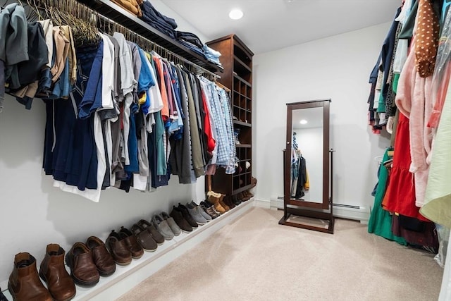 walk in closet featuring a baseboard radiator and carpet