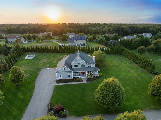 aerial view at dusk featuring a rural view