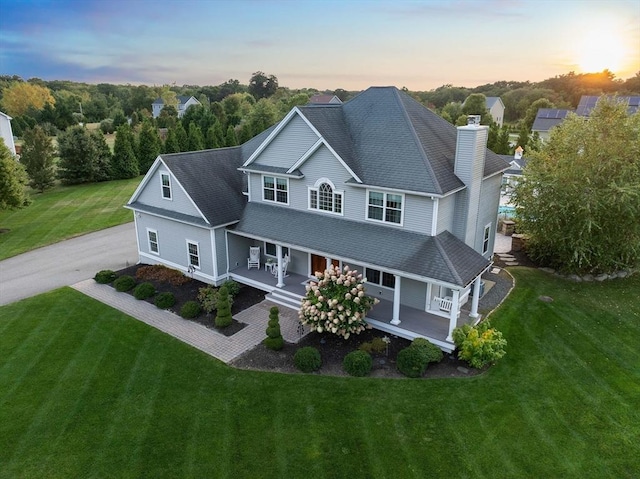 exterior space featuring a yard and covered porch