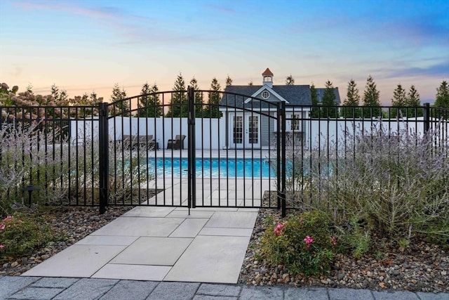 view of pool at dusk