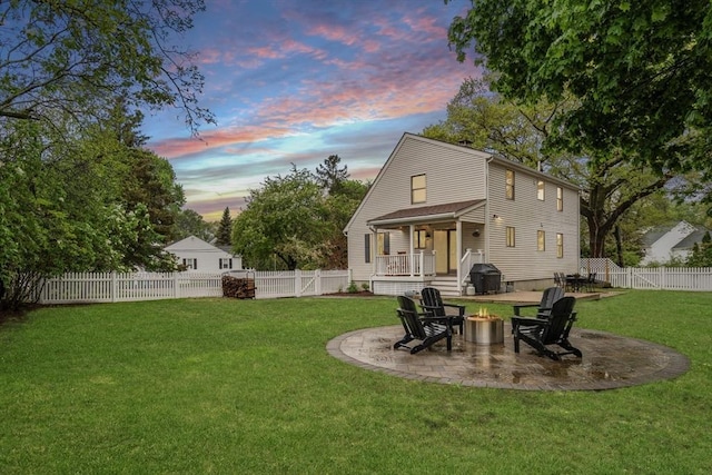 back of house with a fire pit and a patio area