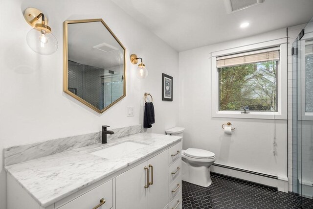 bathroom with a baseboard radiator, vanity, toilet, and a shower