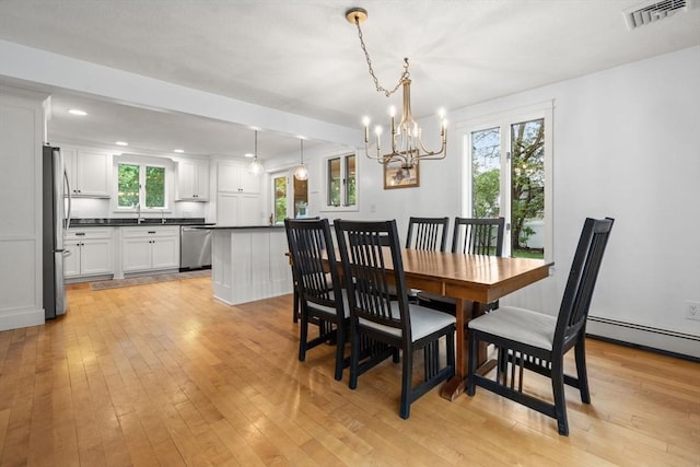 dining space featuring a chandelier, light wood-style floors, and recessed lighting