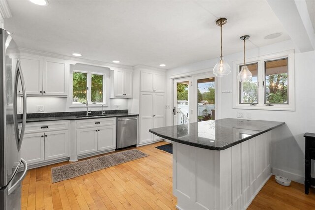 kitchen featuring appliances with stainless steel finishes, a sink, white cabinetry, and recessed lighting