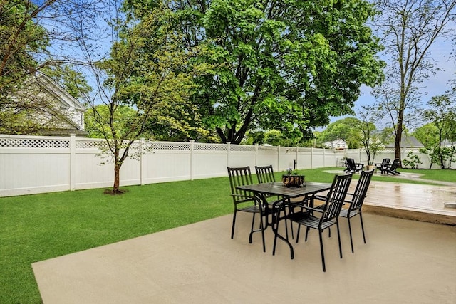 view of patio featuring outdoor dining space and a wooden deck