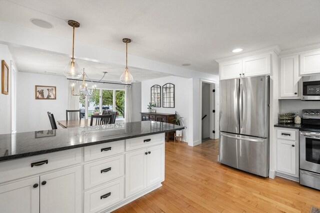 kitchen with stainless steel appliances, white cabinets, light wood finished floors, dark stone counters, and recessed lighting