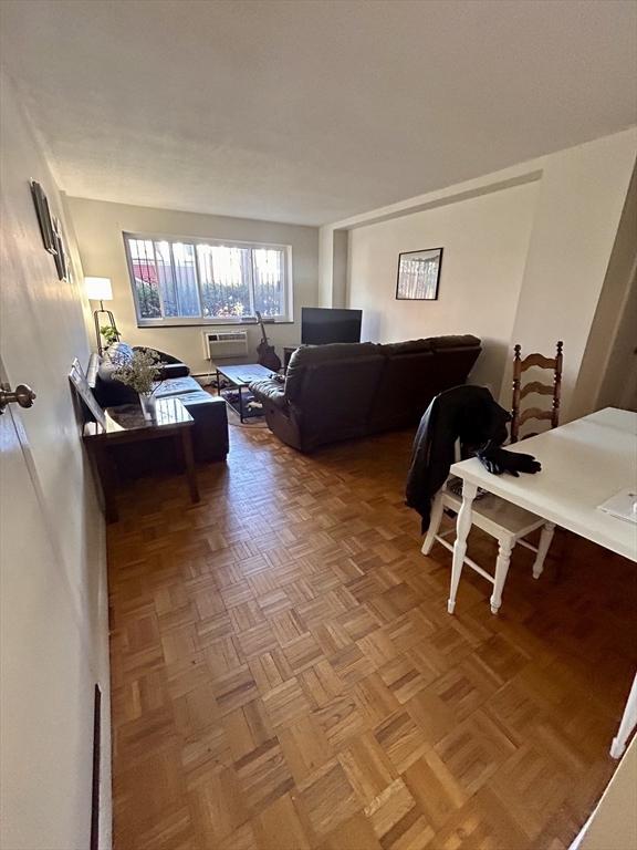 living area featuring a wall mounted air conditioner