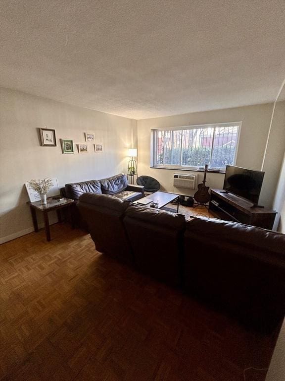 living area with baseboards and a textured ceiling