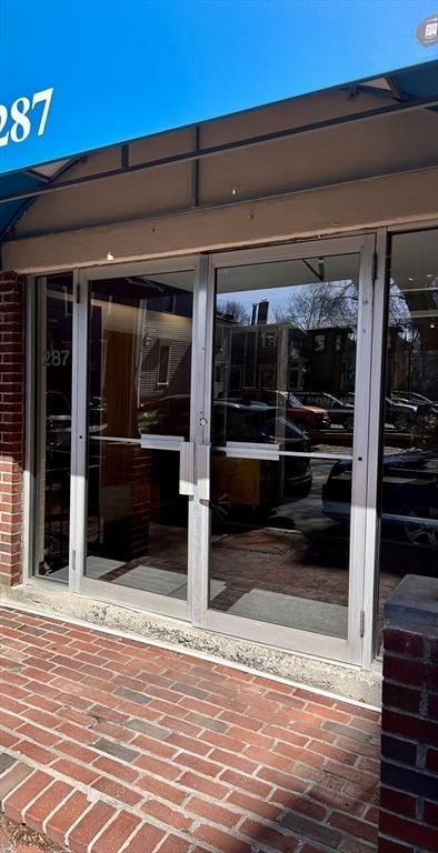 property entrance featuring brick siding